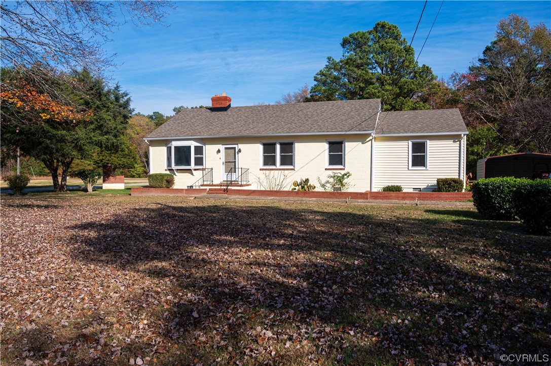 12411 Lewis Road Chester, VA 23831 - Photo 8 of 34 a front view of a house with a yard