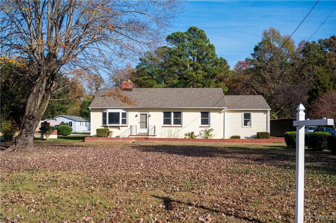 12411 Lewis Road Chester, VA 23831 - Photo 9 of 34 a front view of a house with a yard