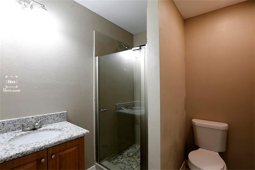 1112 Georgina Street Rosenberg, TX 77471 - Photo 13 of 14 a bathroom with a granite countertop sink toilet and shower
