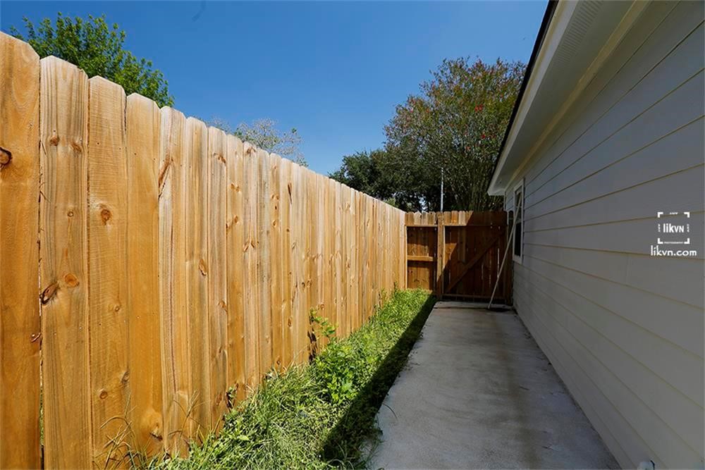 1112 Georgina Street Rosenberg, TX 77471 - Photo 14 of 14 a view of a back yard with a wooden fence
