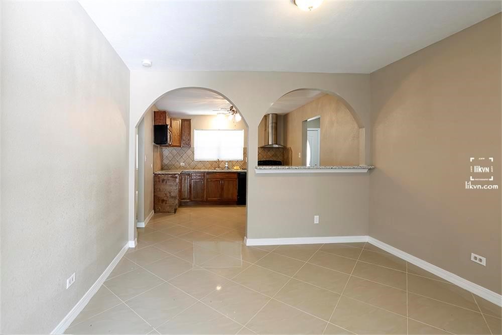 1112 Georgina Street Rosenberg, TX 77471 - Photo 5 of 14 an empty room with a fireplace and a bathroom