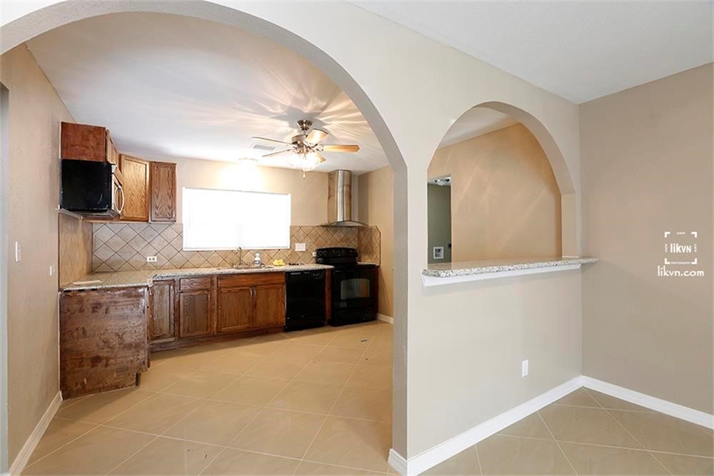 1112 Georgina Street Rosenberg, TX 77471 - Photo 6 of 14 a large kitchen with a large counter top cabinets and stainless steel appliances