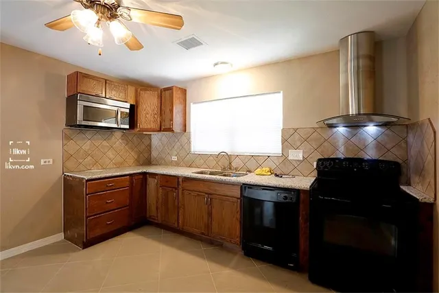 a kitchen with a stove sink and microwave