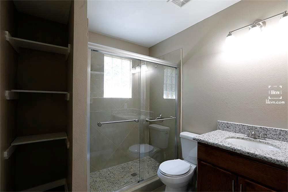 1112 Georgina Street Rosenberg, TX 77471 - Photo 10 of 14 a bathroom with a granite countertop toilet a sink and a shower