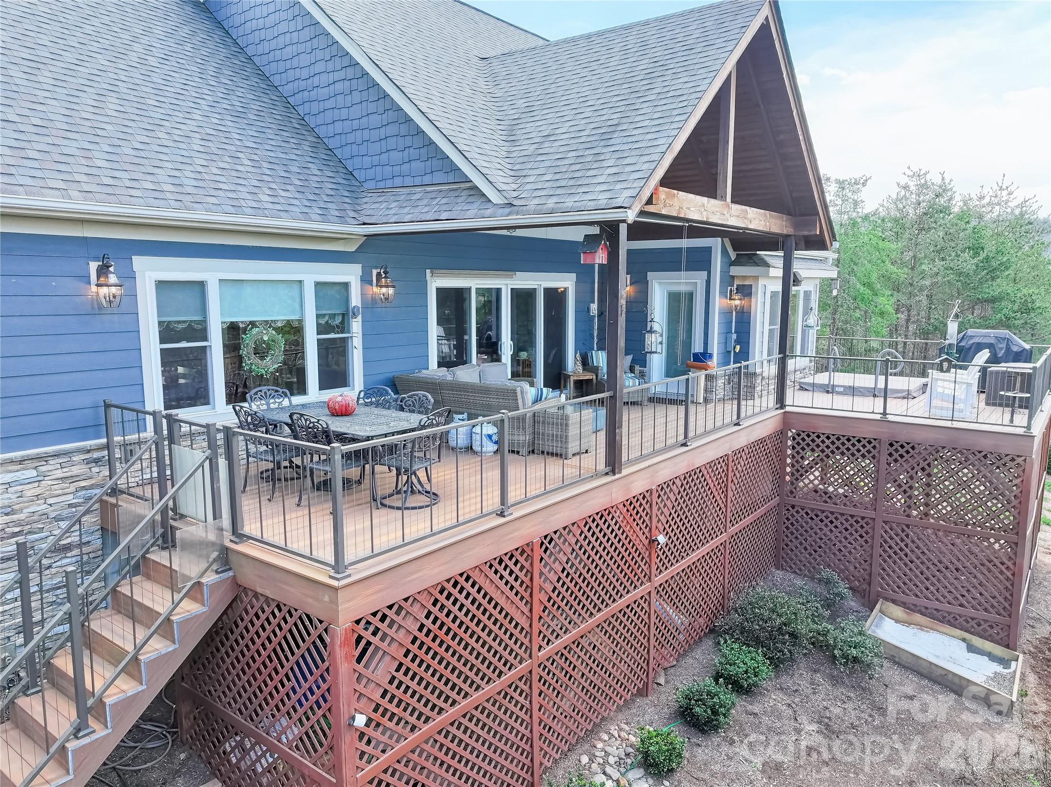 1103 River Ridge Way Lenoir, NC 28645 - Photo 37 of 46 a view of a house with wooden deck and furniture