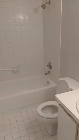 a bathroom with a toilet and a bathtub