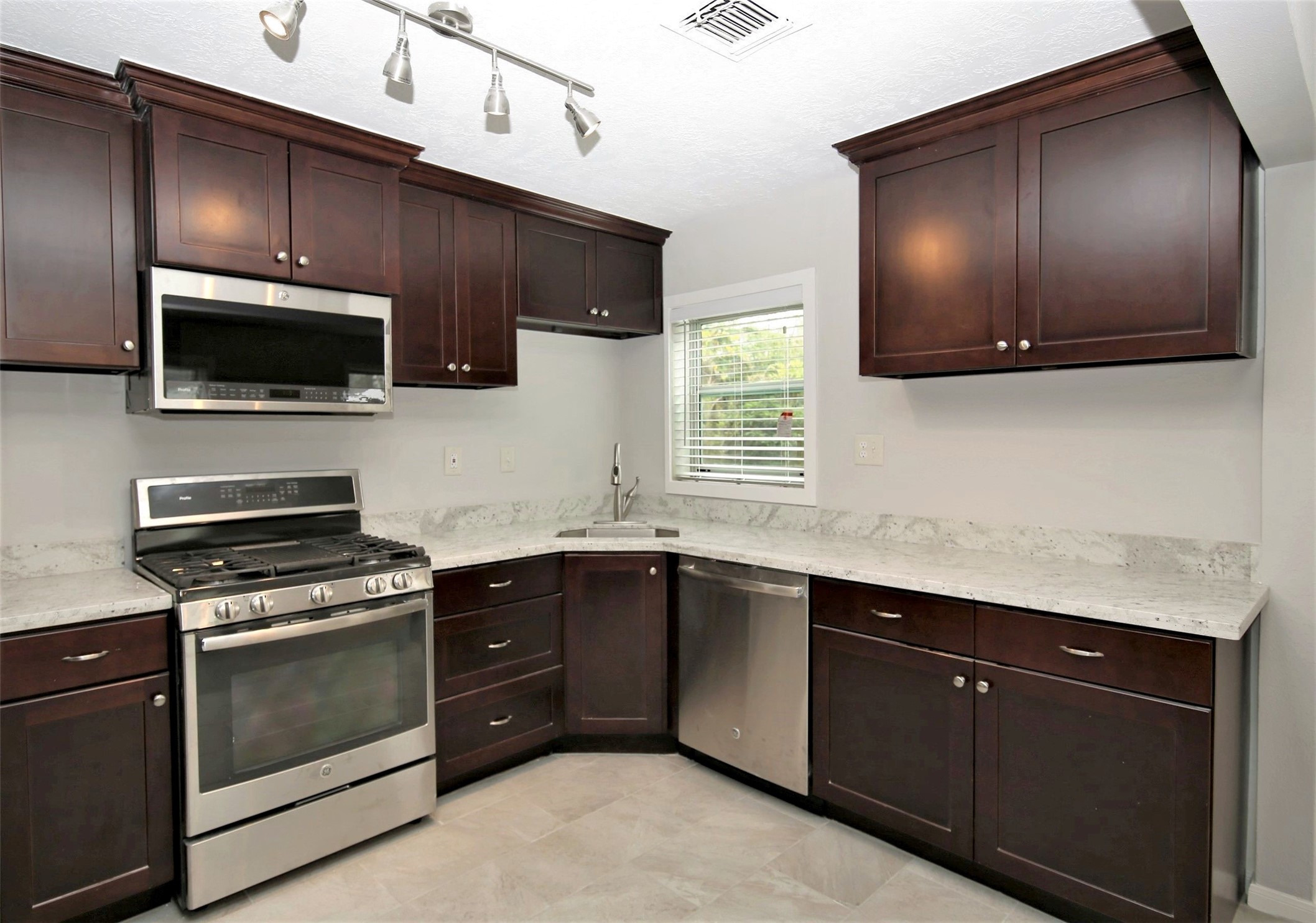 4830 Culmore Drive Houston, TX 77021 - Photo 5 of 13 a kitchen with a sink stove and microwave