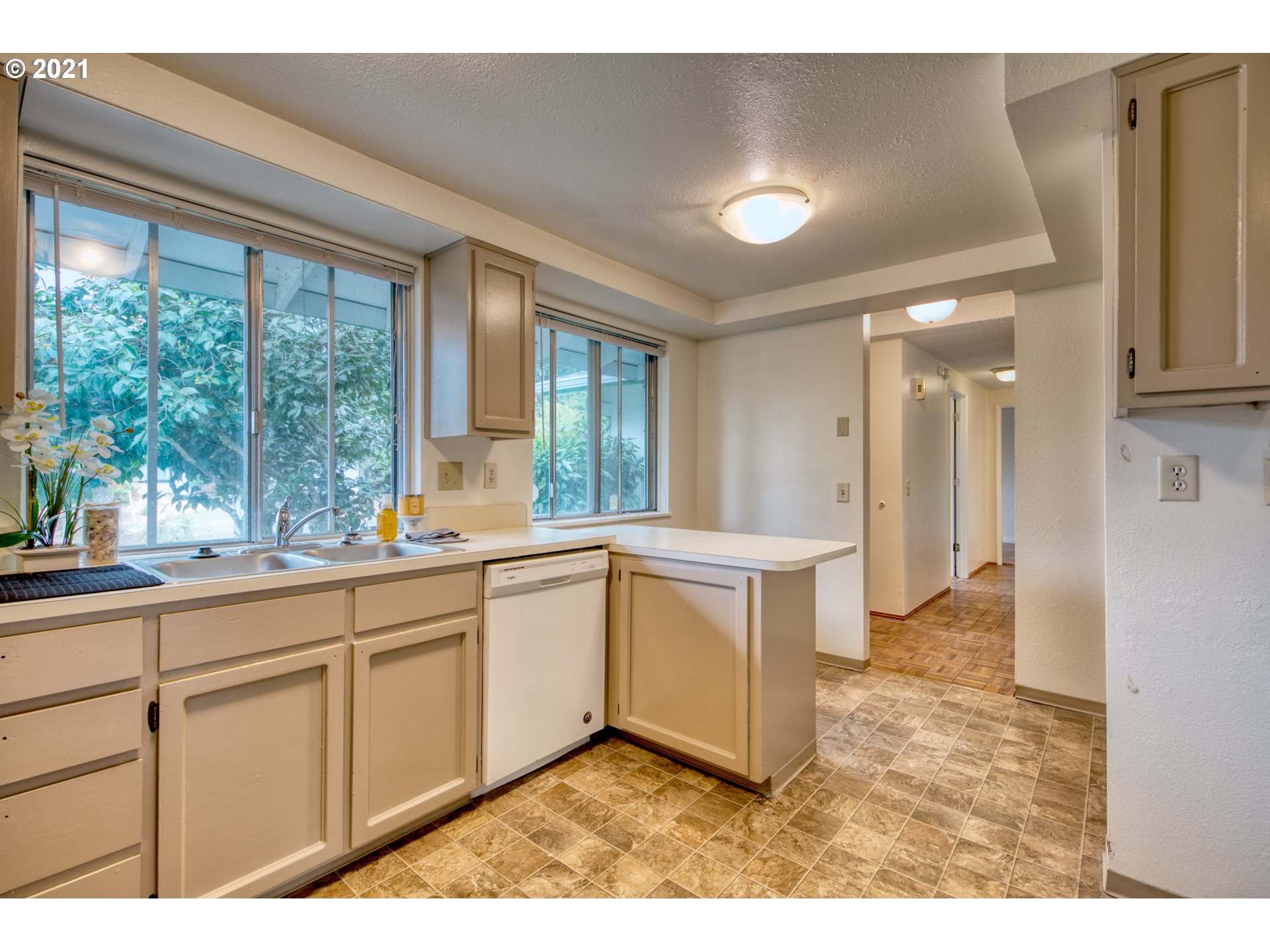 6509 E Street Springfield, OR 97478 - Photo 3 of 28 a large white kitchen with sink and windows