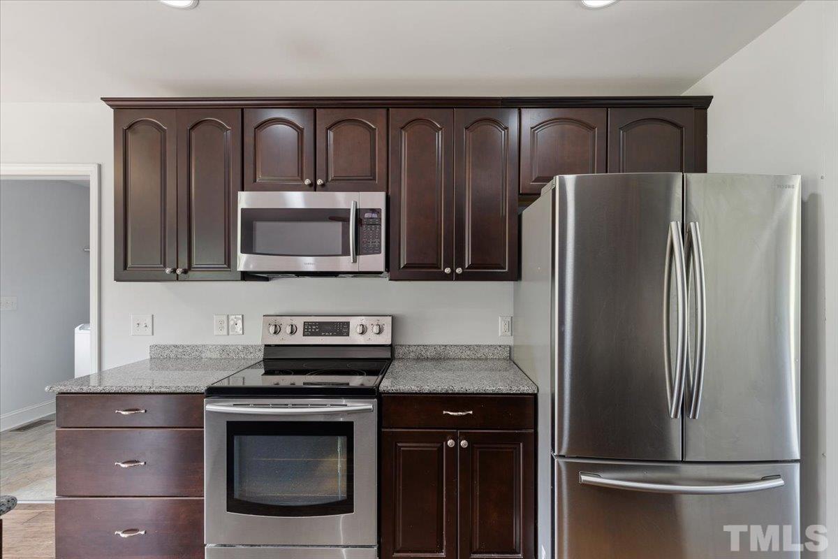 11208 Range Road Rougemont, NC 27572 - Photo 12 of 40 a kitchen with granite countertop stainless steel appliances and refrigerator