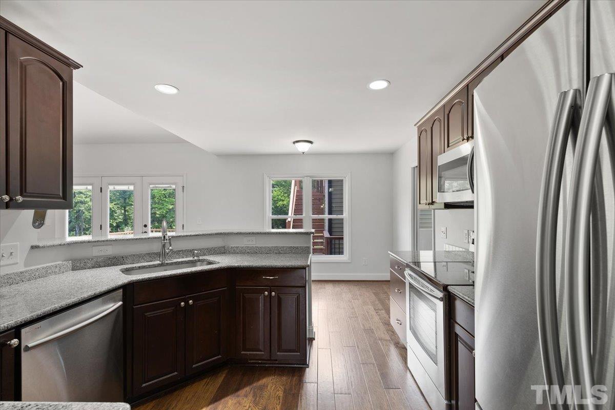 11208 Range Road Rougemont, NC 27572 - Photo 13 of 40 a kitchen with granite countertop a refrigerator and a sink