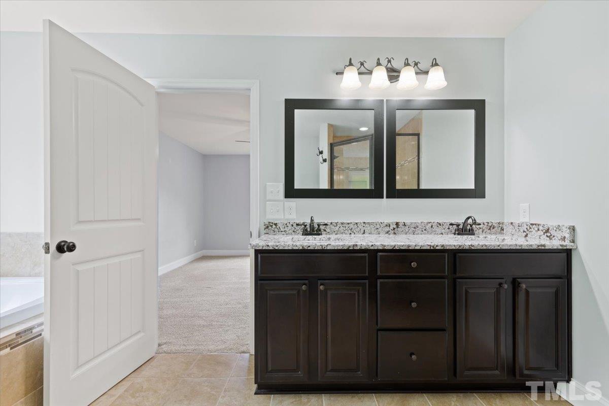 11208 Range Road Rougemont, NC 27572 - Photo 18 of 40 a bathroom with a double vanity sink and mirror