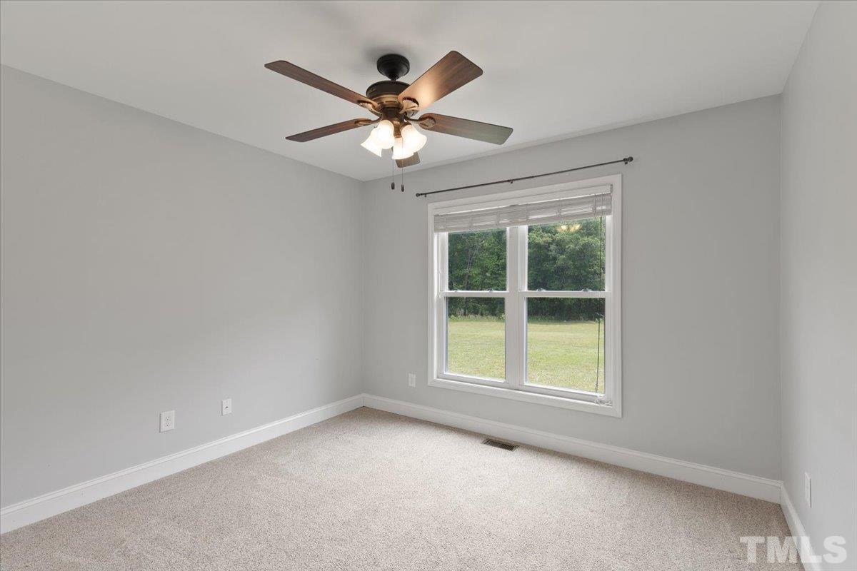 11208 Range Road Rougemont, NC 27572 - Photo 21 of 40 an empty room with a window and a fan