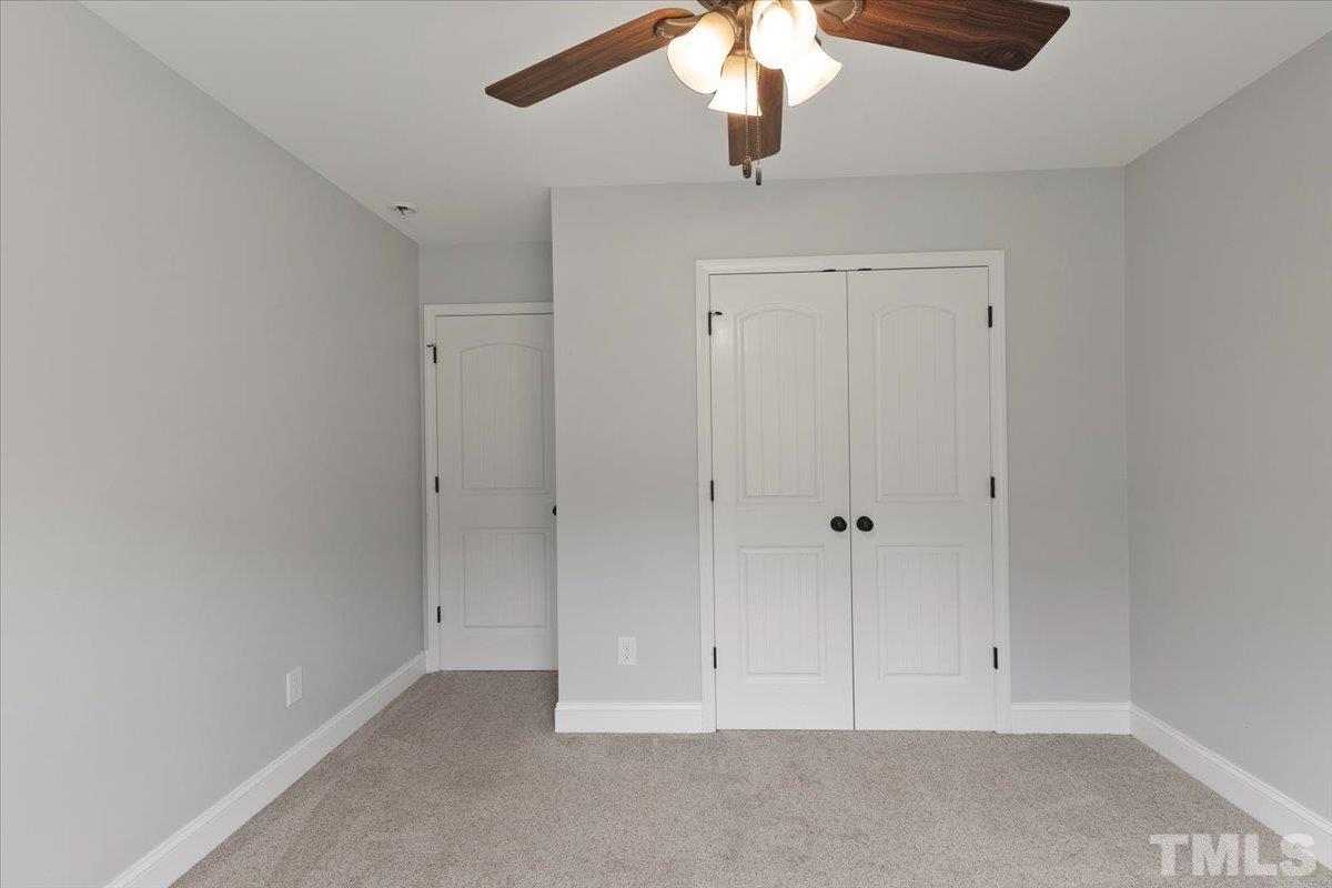 11208 Range Road Rougemont, NC 27572 - Photo 22 of 40 an empty room with a ceiling fan