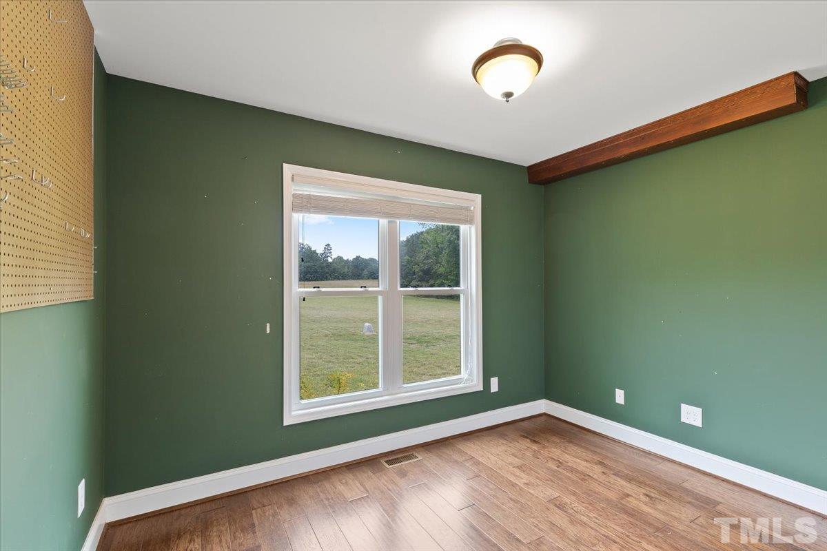 11208 Range Road Rougemont, NC 27572 - Photo 24 of 40 a view of an empty room with window and wooden floor