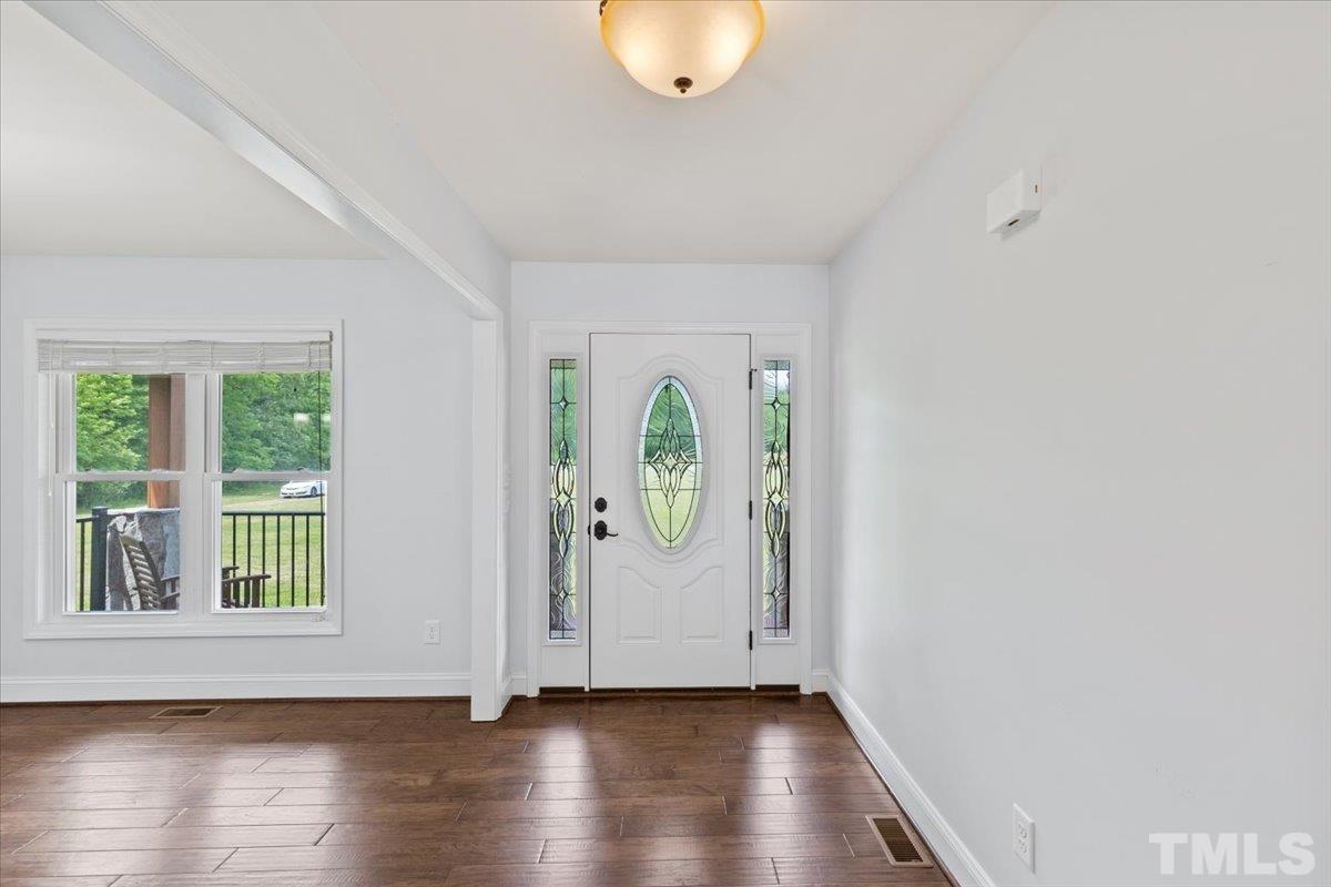 11208 Range Road Rougemont, NC 27572 - Photo 4 of 40 an empty room with wooden floor and windows