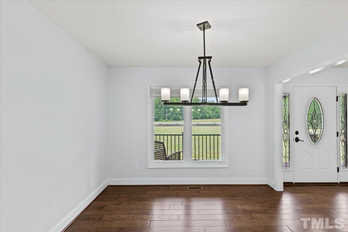 11208 Range Road Rougemont, NC 27572 - Photo 5 of 40 a view of a room with wooden floor windows and a chandelier