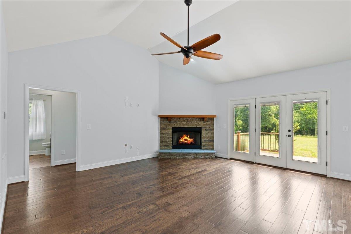 11208 Range Road Rougemont, NC 27572 - Photo 6 of 40 a view of an empty room with wooden floor fireplace and a window