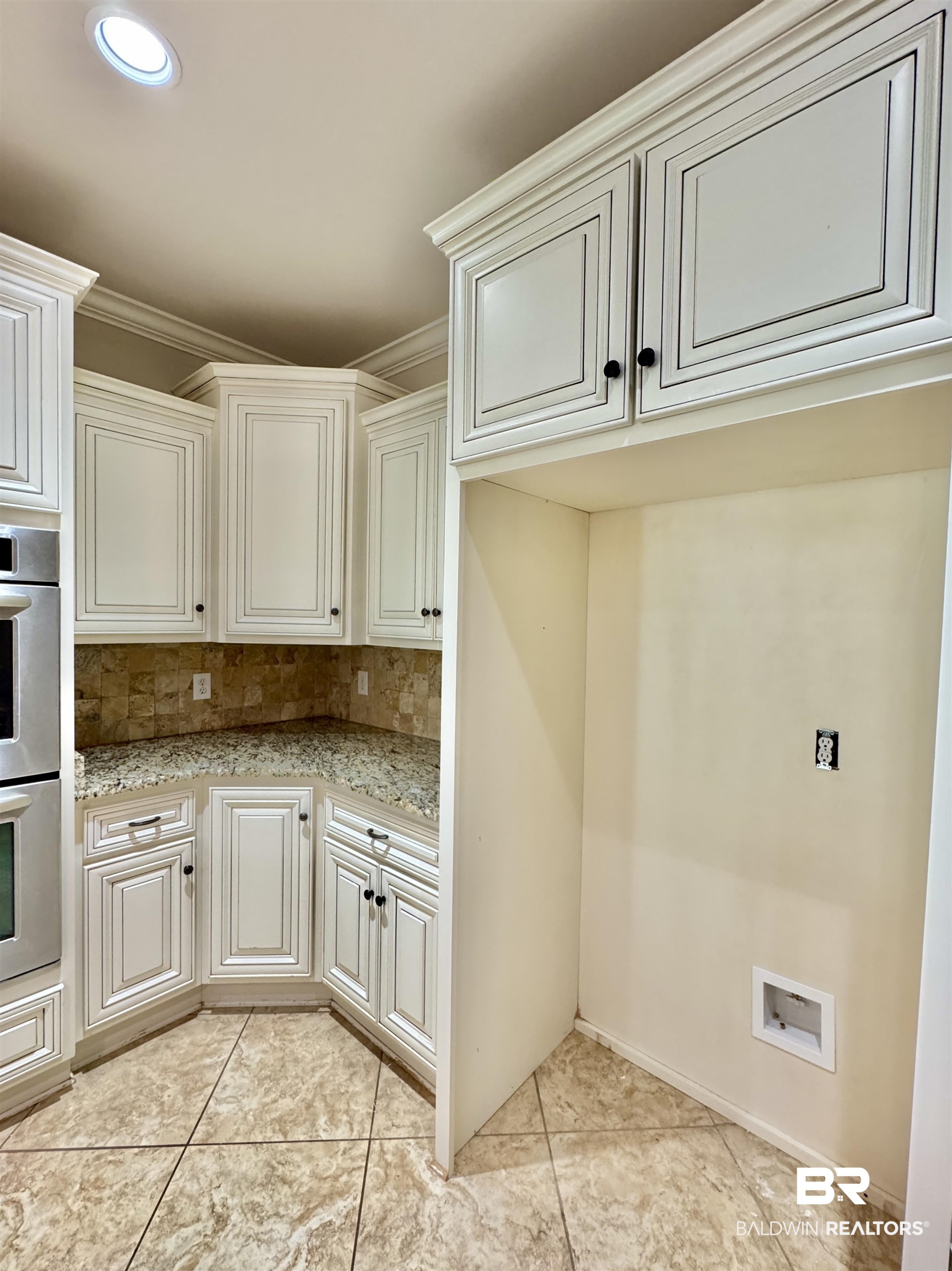 10846 County Road 138 Bay Minette, AL 36507 - Photo 6 of 53 Kitchen with decorative backsplash, light stone countertops, light tile patterned flooring, crown molding, and stainless steel double oven