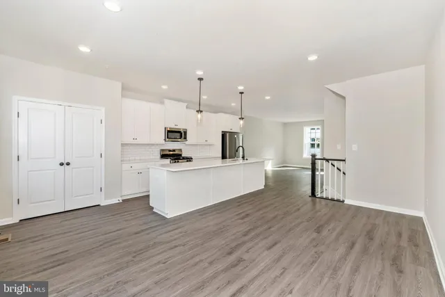 a view of kitchen with wooden floor and electronic appliances
