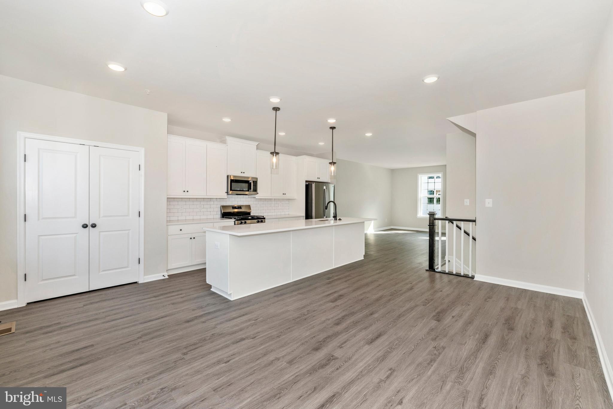 101 Spring Bank Way Frederick, MD 21701 - Photo 12 of 20 a view of kitchen with wooden floor and electronic appliances