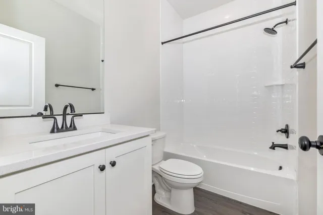 a bathroom with a sink a toilet and a bathtub