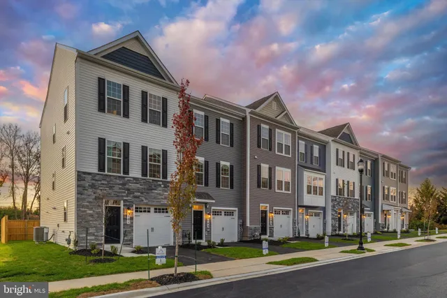 a front view of a building with a yard