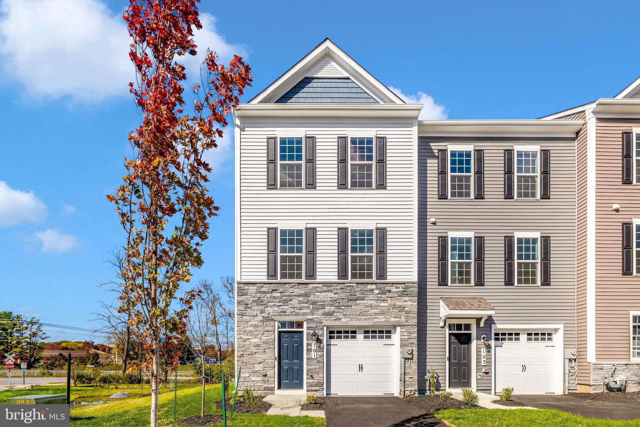 101 Spring Bank Way Frederick, MD 21701 - Photo 2 of 20 a front view of a house with a garden