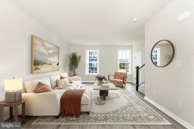 a living room with furniture a mirror and a large window
