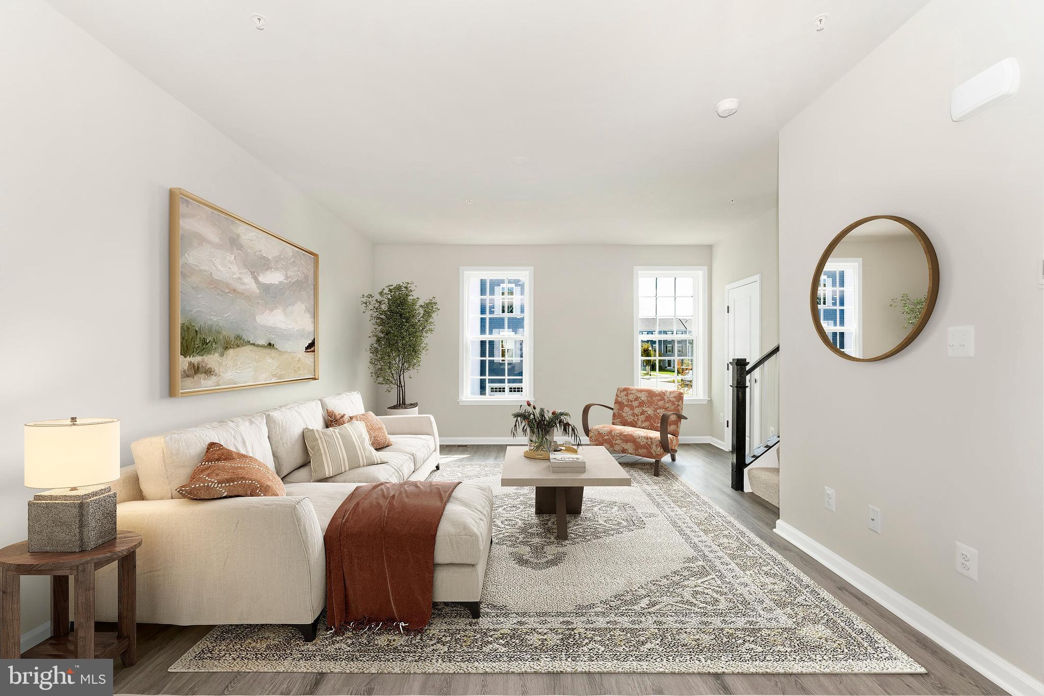 101 Spring Bank Way Frederick, MD 21701 - Photo 5 of 20 a living room with furniture a mirror and a large window