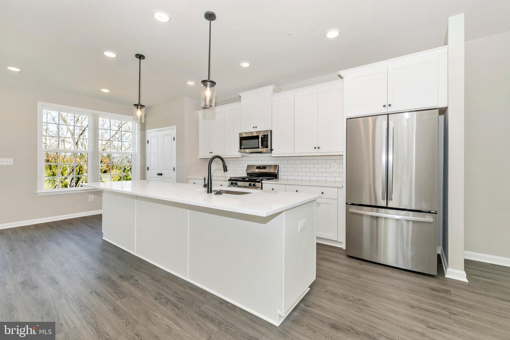101 Spring Bank Way Frederick, MD 21701 - Photo 9 of 20 a kitchen with stainless steel appliances granite countertop a refrigerator a stove a sink and a microwave