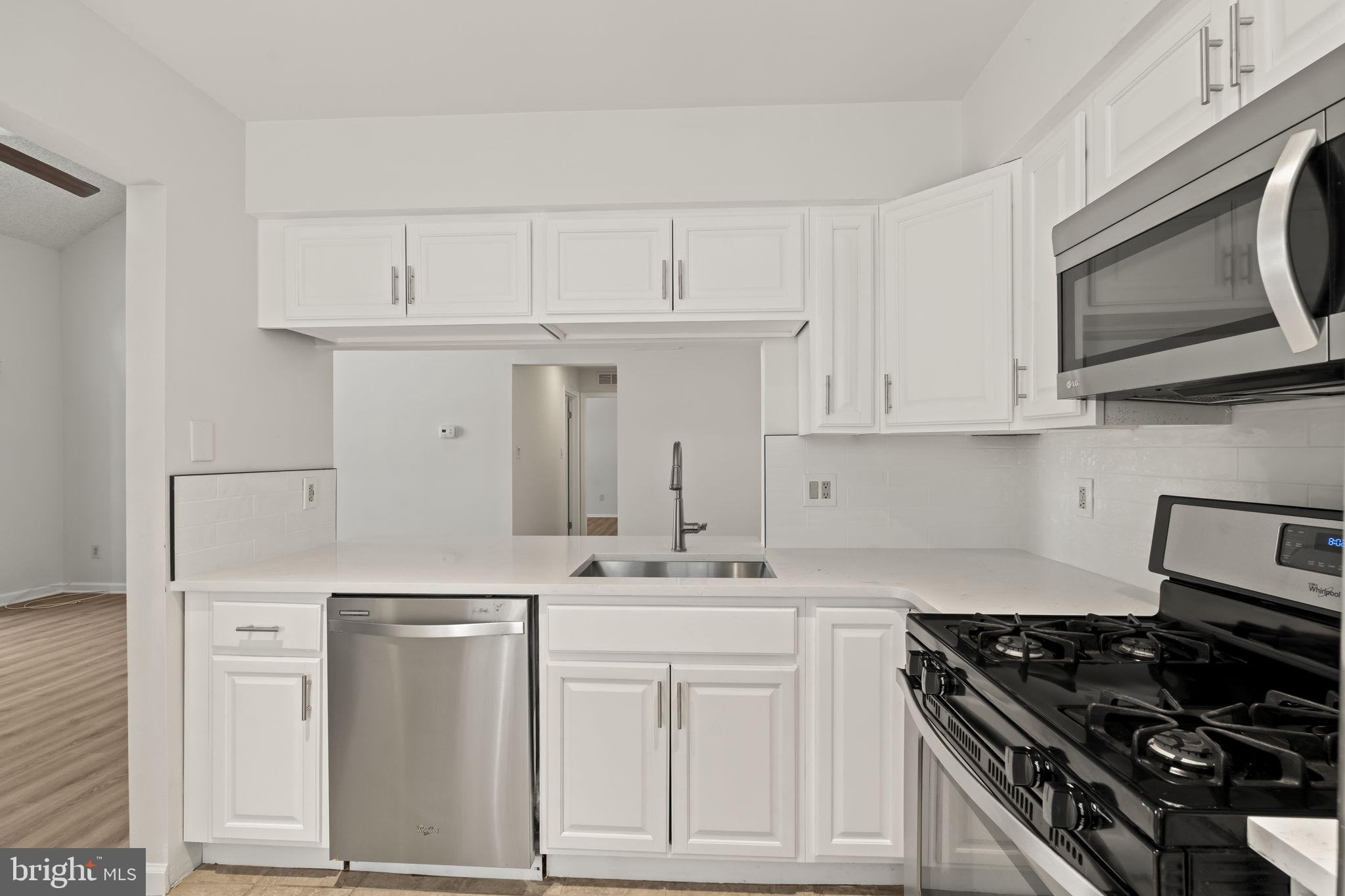5508 B Albridge Way Mount Laurel, NJ 08054 - Photo 12 of 27 a kitchen with white cabinets and appliances