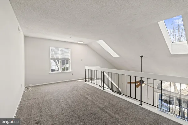 a view of an empty room with windows