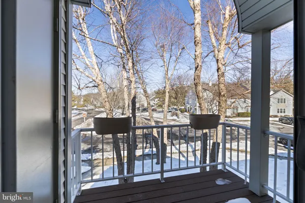 a view of balcony with a couple of large trees