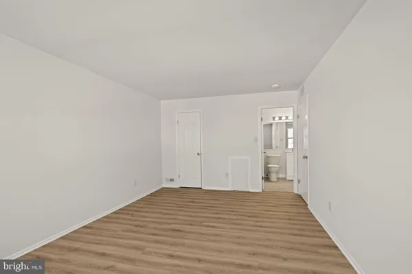 a view of a room with wooden floor