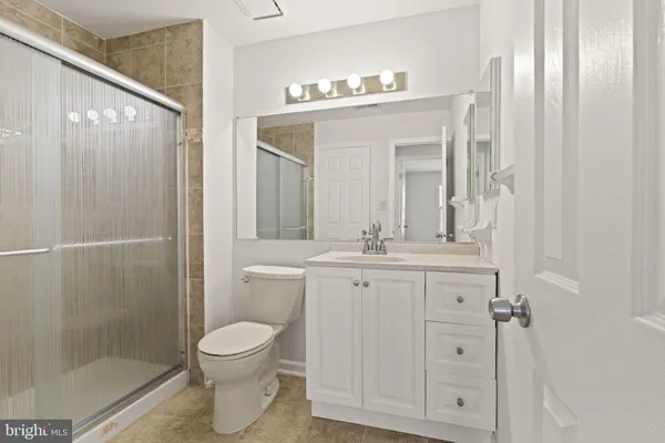 a bathroom with a toilet a sink and a mirror
