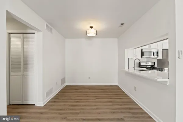 a view of a kitchen cabinets and wooden floor