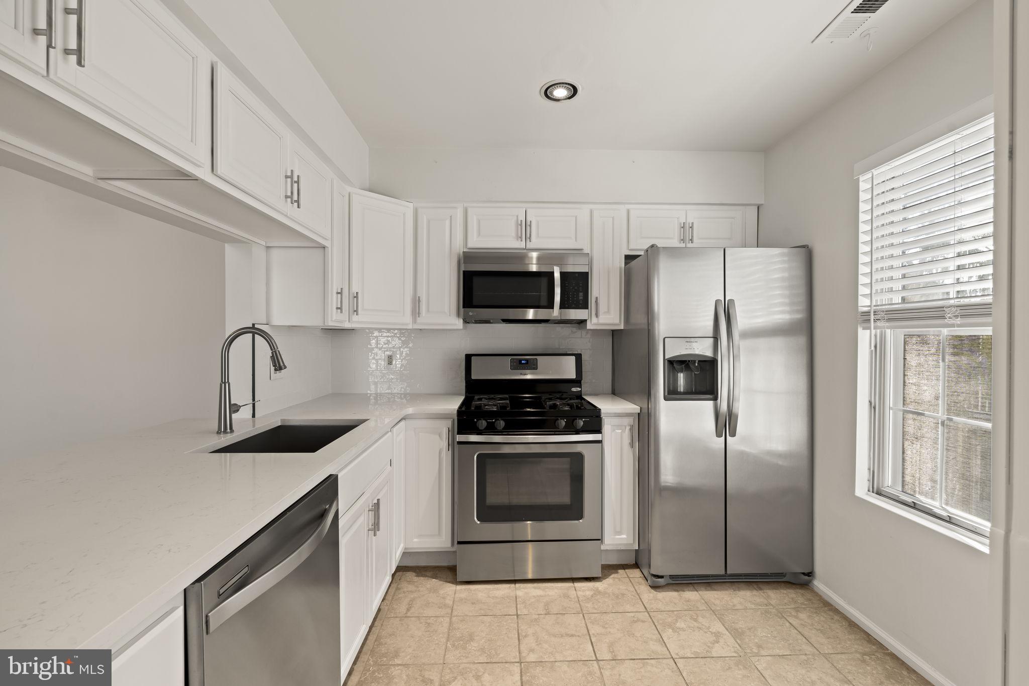 5508 B Albridge Way Mount Laurel, NJ 08054 - Photo 10 of 27 a kitchen with stainless steel appliances a refrigerator sink and cabinets
