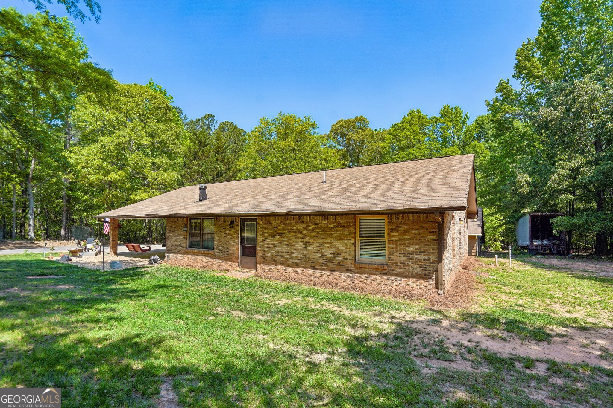 241 Busbin Road Fayetteville, GA 30215 - Photo 3 of 45 an outdoor view of house with backyard and green space