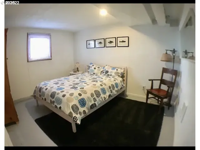 a bed sitting in a bedroom and chair