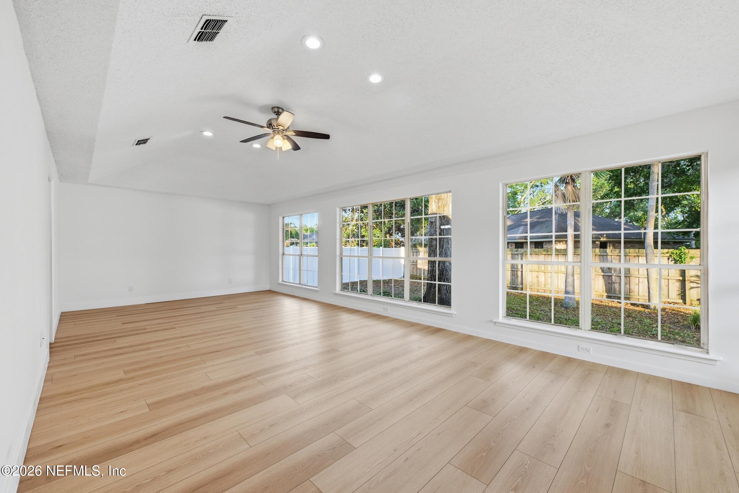 3286 Marbon Road Jacksonville, FL 32223 - Photo 26 of 36 a view of empty room with wooden floor and fan