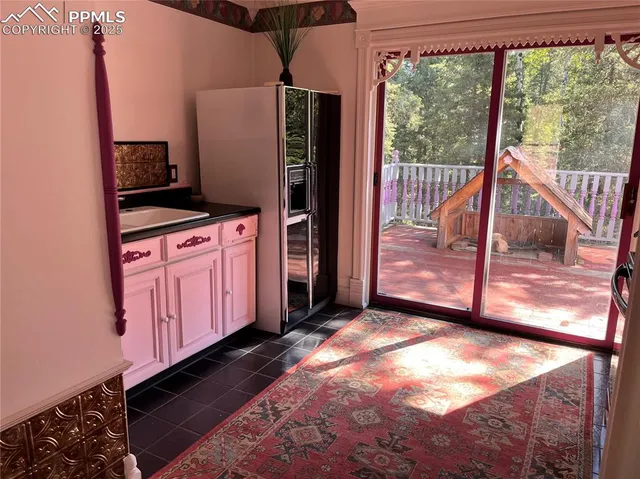 a kitchen with stainless steel appliances granite countertop a stove a refrigerator and wooden cabinets