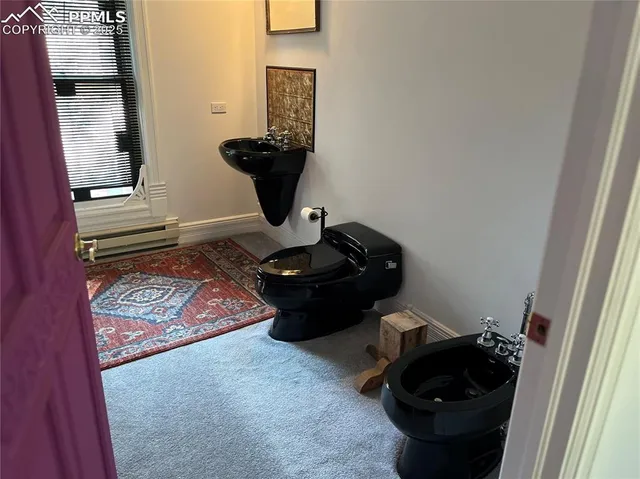 a room with wooden floor and a utility room