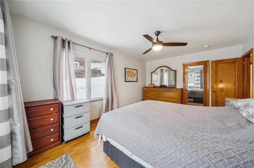 811 5th Street Trafford, PA 15085 - Photo 13 of 36 a bedroom with a bed and a dresser with mirror