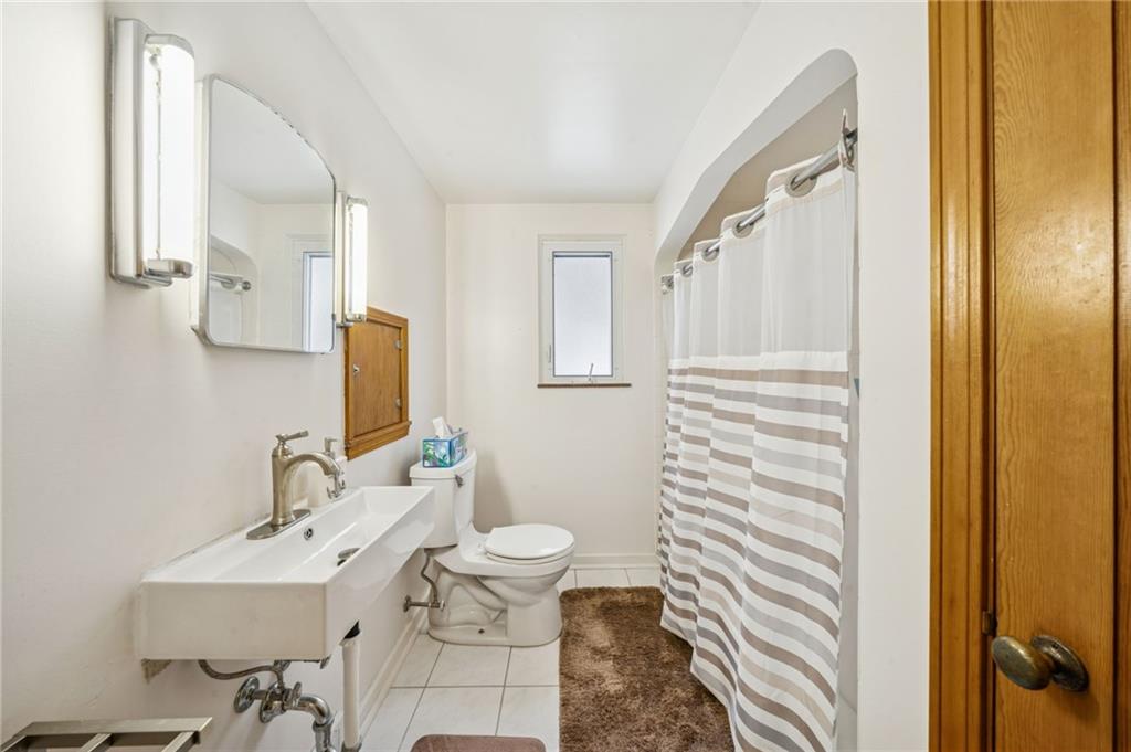 811 5th Street Trafford, PA 15085 - Photo 19 of 36 a bathroom with a sink toilet and mirror