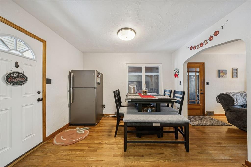 811 5th Street Trafford, PA 15085 - Photo 8 of 36 a living room with furniture a dining table and a refrigerator