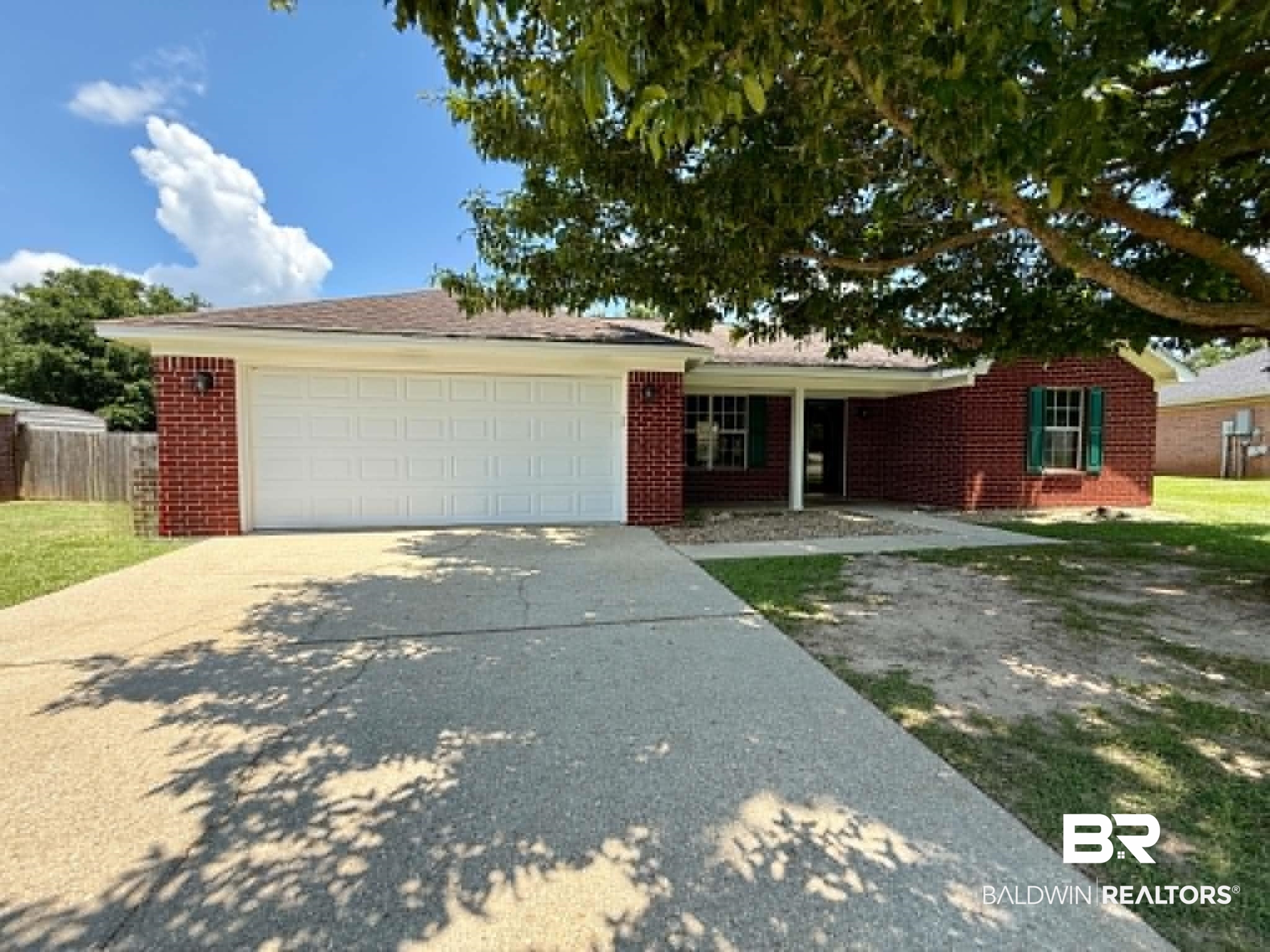 123 Pennbrooke Loop Foley, AL 36535 - Photo 1 of 49 Red brick exterior featuring a covered porch entry and a two-car garage