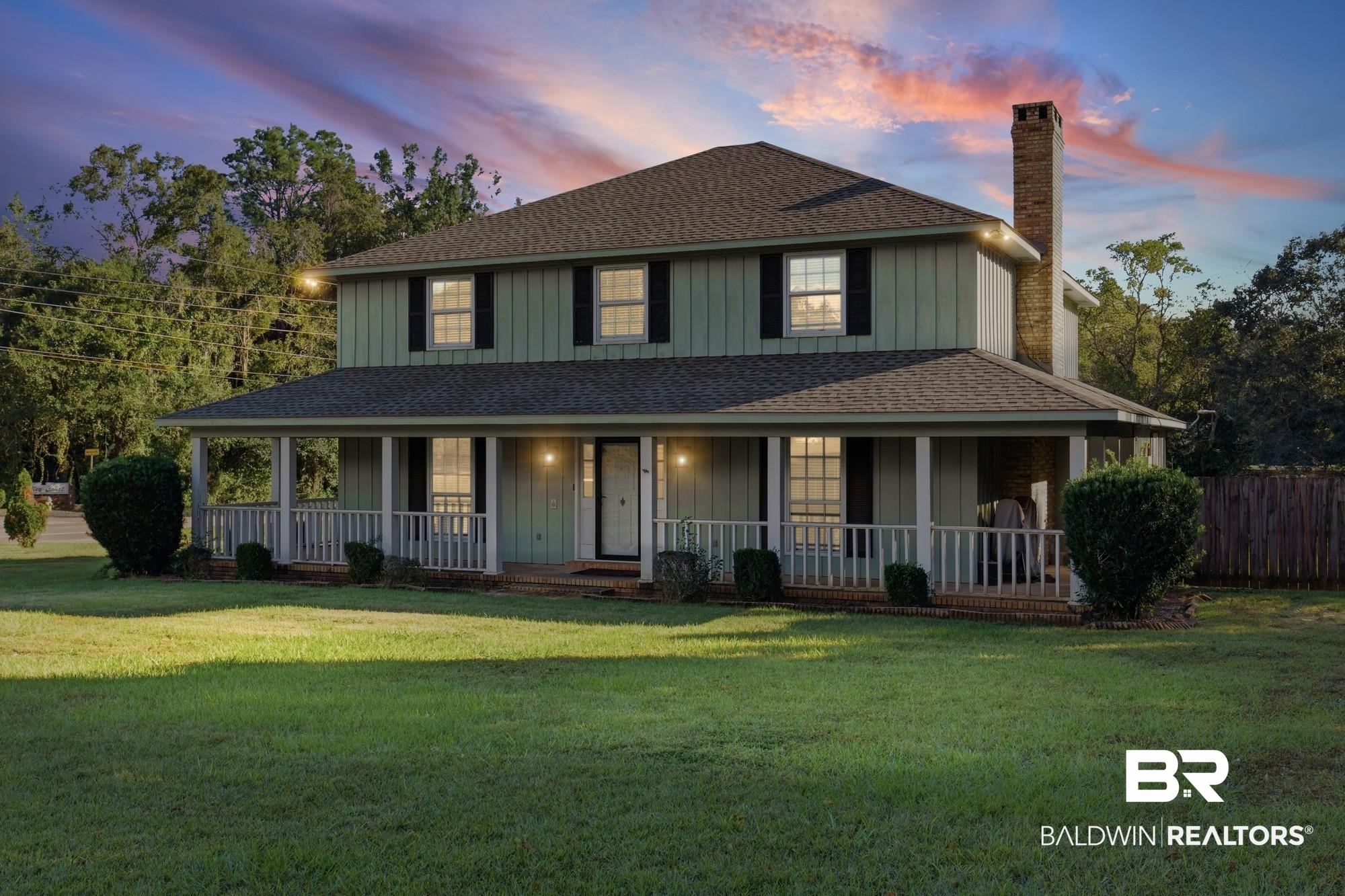 9215 Shiloh Drive Mobile, AL 36695 - Photo 4 of 32 Country-style home with a shingled roof, covered porch, a chimney, board and batten siding, and a lawn