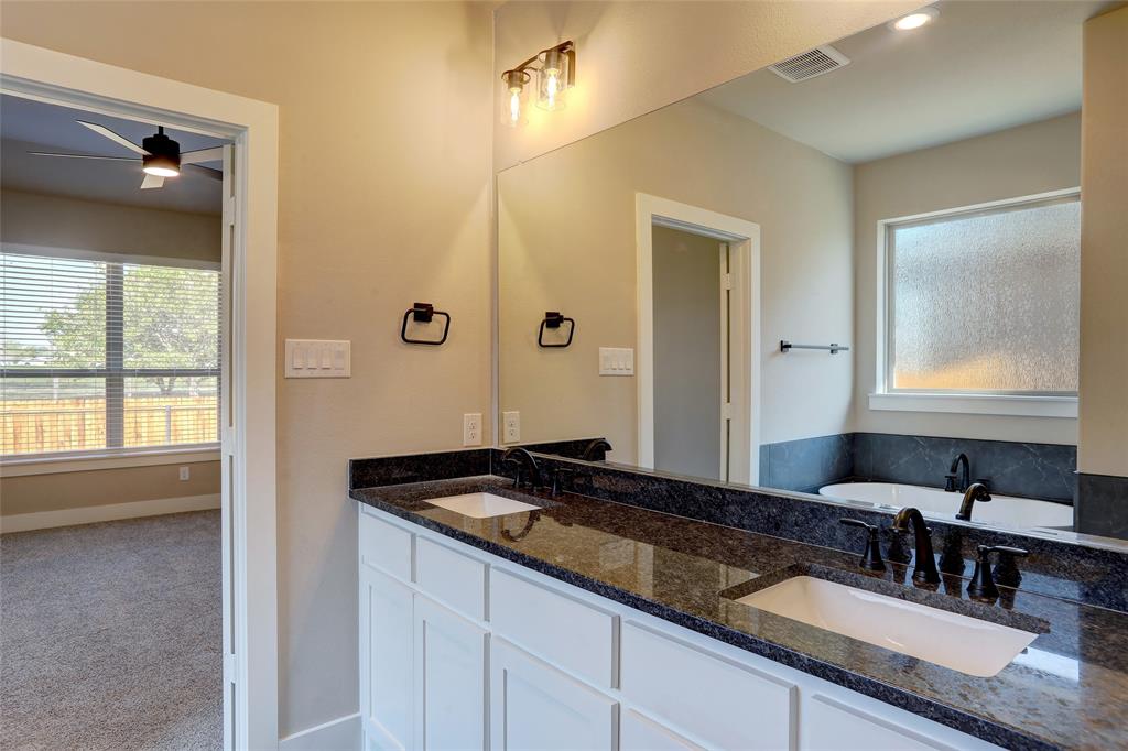 202 Pennington Road Josephine, TX 75173 - Photo 11 of 23 a bathroom with a granite countertop sink and a mirror