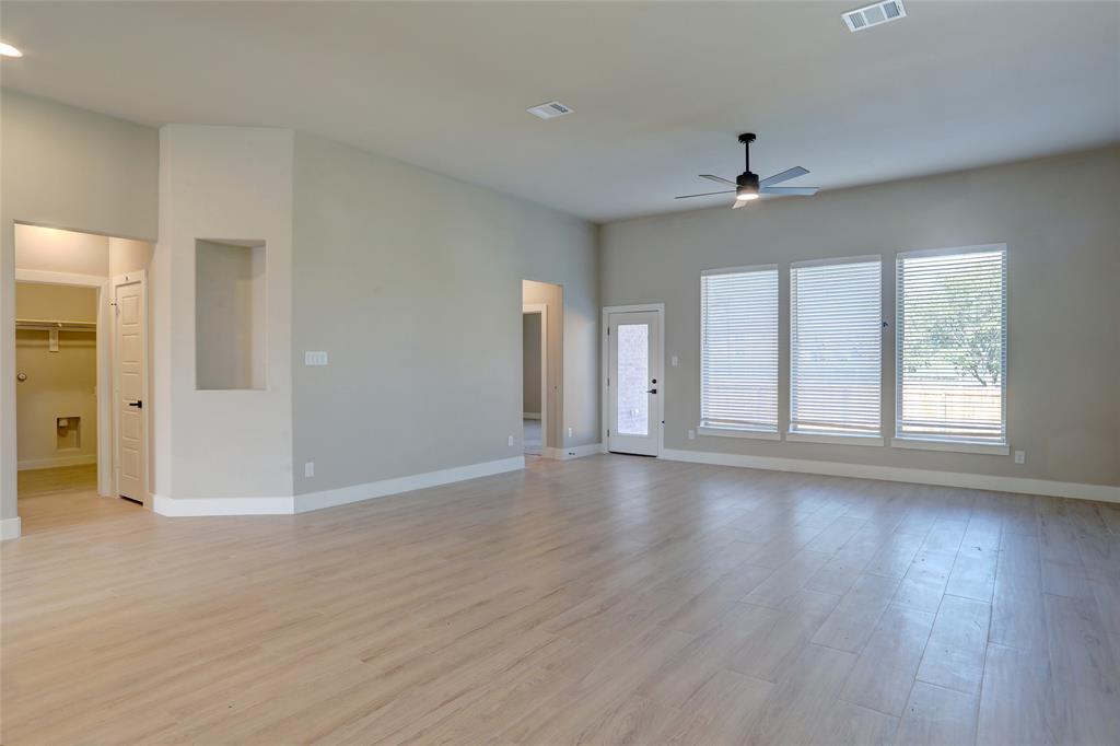 202 Pennington Road Josephine, TX 75173 - Photo 3 of 23 a view of an empty room with wooden floor and a window
