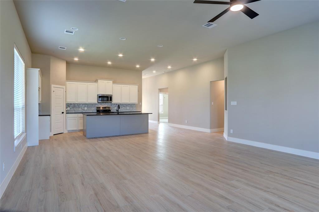 202 Pennington Road Josephine, TX 75173 - Photo 22 of 23 a view of kitchen with kitchen island wooden floor center island and stainless steel appliances